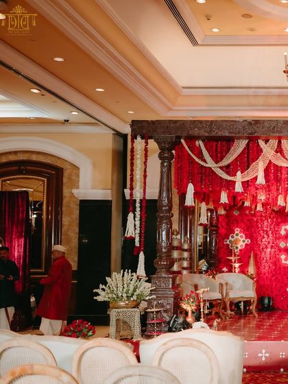 The mandap for this indoor Marathi wedding featured rich red drapes and traditional wooden pillars. The design blended cultural authenticity with grandeur, creating a warm and opulent space that honored the couple's heritage.