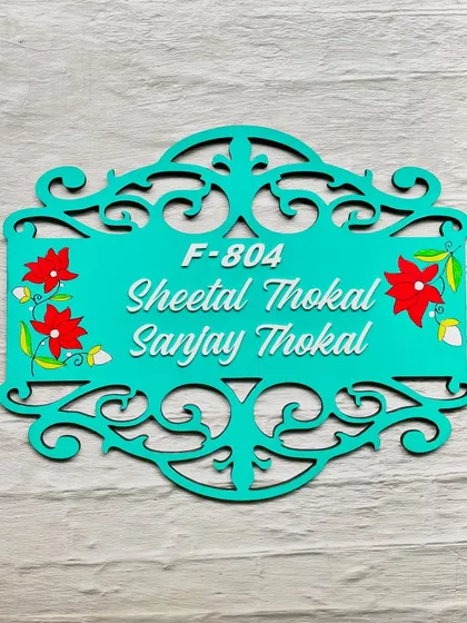 This wooden nameplate features a laser-cut border with intricate floral details, hand-painted to add a pop of color. It’s a wonderful choice for a sophisticated and artistic entrance.