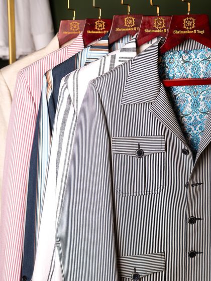 A collection of striped jackets, each with a unique patterned lining. This image showcases our belief that the inside of a garment should be just as personal and well-crafted as the outside.