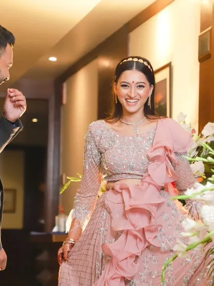 The groom's joyful reaction upon seeing his stunning bride-to-be at their engagement. Her bright smile shows her happiness in this beautiful, candid moment.