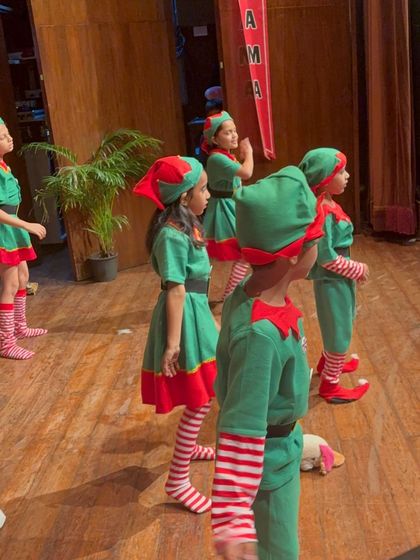 A group of elves in formation, listening for their next cue during the Christmas play.