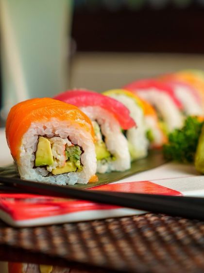 A close-up of our Niji Maki, showcasing the fresh slice of salmon and creamy avocado. It is a testament to the quality and craftsmanship we pour into every roll.