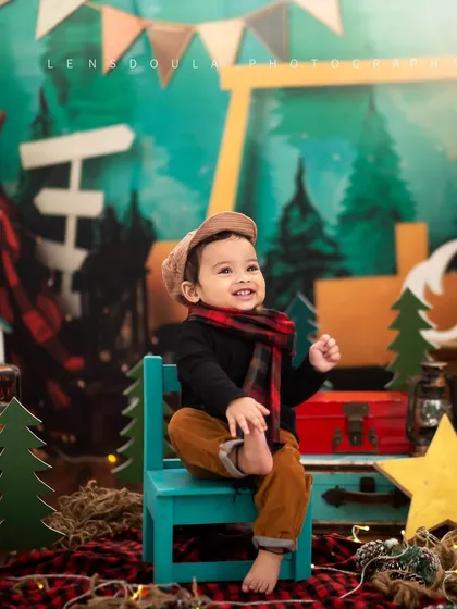 A candid moment of play. This little boy's happy expression shows how much fun a themed photoshoot can be.