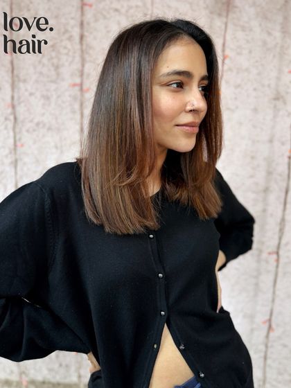 The side profile of our lux brunette bob. The subtle, face-framing highlights are placed to enhance the client's features and the sharp lines of the cut.