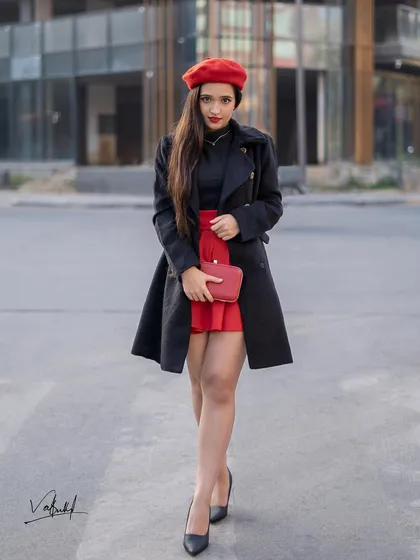 Capturing the chic and effortless 'Emily in Paris' vibe right here on the streets. This shot combines a bold red and black outfit with a modern urban background to create a story of sophisticated style.