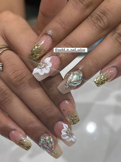 Perfect for wedding shenanigans, this design combines gold glitter, 3D white flowers, and a large, eye-catching crystal on the ring finger. A true statement set for any bride or bridesmaid.