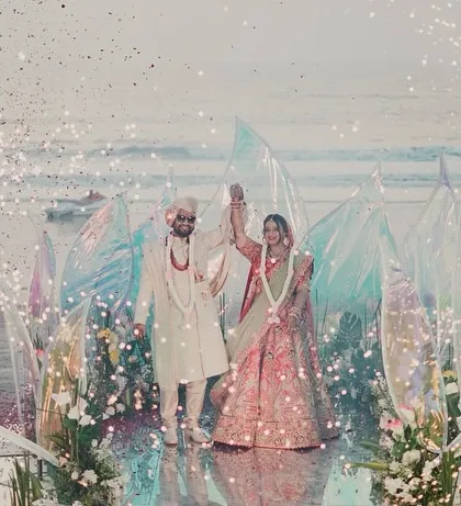 For this destination wedding, I created a modern, ethereal mandap right on the beach. The iridescent panels caught the light beautifully, and the surrounding sparklers made the couple's special moment feel like a scene from a movie.