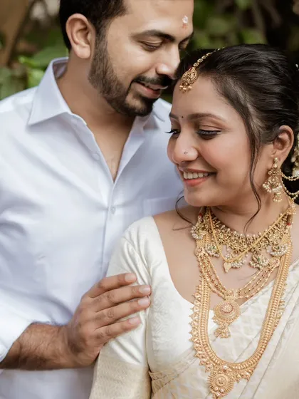 A tender moment captured during a South Indian wedding. The groom's gentle touch and the bride's serene smile create a portrait filled with warmth and emotion.