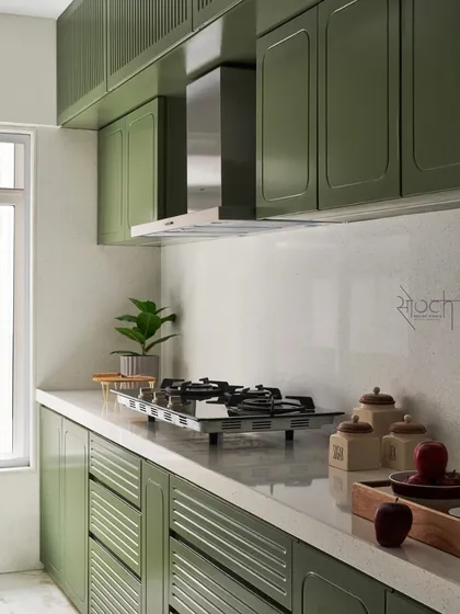 The kitchen design is a symphony of tradition and modernity, with olive green furniture and a stunning terrazzo countertop.