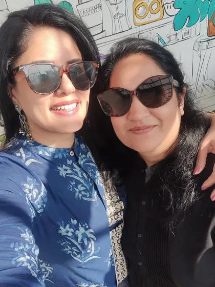 A happy selfie with my college friend, both of us in our sunglasses and ready for a sunny day chat.