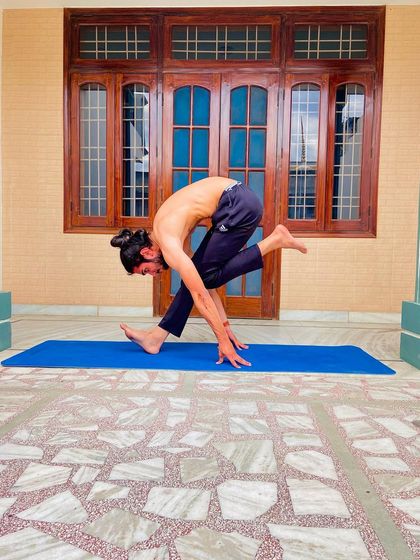 A standing forward bend variation, a great stretch for the hamstrings and lower back.