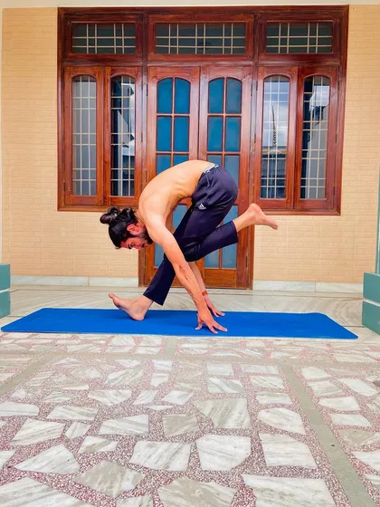 A standing forward bend variation, a great stretch for the hamstrings and lower back.