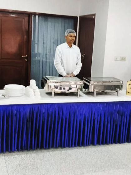 A smart and professional buffet setup for a corporate catering event for 35 guests at ALLTERRA SOLUTIONS. The blue and white theme adds a touch of corporate branding.