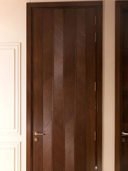 Another view of the American walnut chevron door, showing its elegant proportions and how the pattern creates a sense of movement.