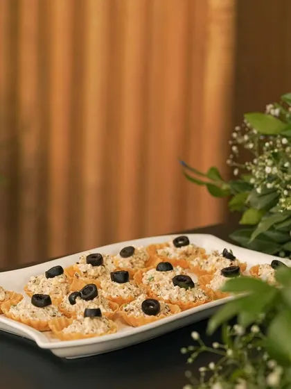 A tray of my creamy mushroom and olive tarts, beautifully arranged for a catering event. These canapés are designed to be both delicious and easy for guests to enjoy.
