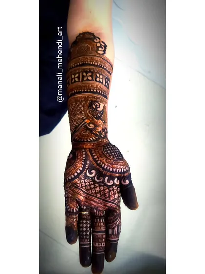 A single-hand design packed with detail. The dark, rich stain is a result of high-quality henna and proper application, and the patterns include a mix of peacocks, florals, and fine line work.