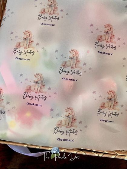 Personalized wrapping paper adds another layer of thoughtfulness. For this gift, I designed custom paper featuring a gentle unicorn and the baby's name.