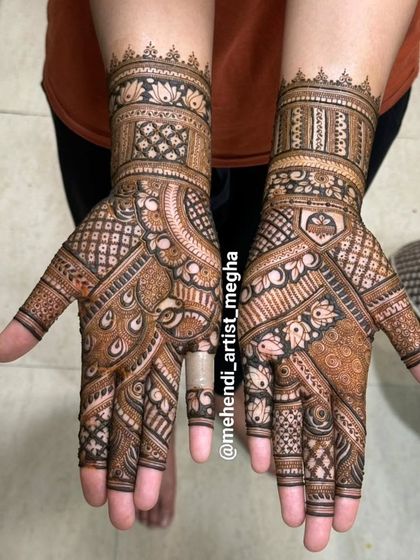 This design is filled with classic elements, including peacock feathers and lotus buds, creating a rich tapestry of traditional art on the hands.