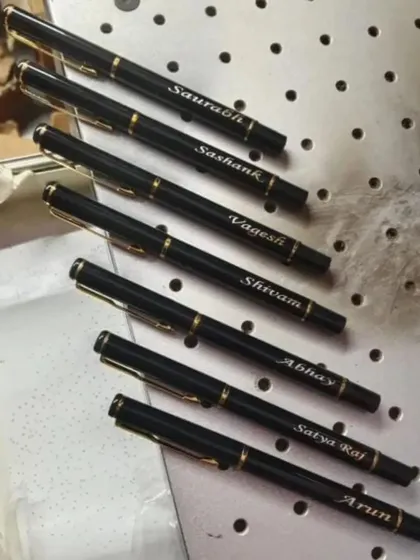 A set of personalized black and gold pens, each engraved with a different name. These are perfect for bulk orders or corporate gifting.