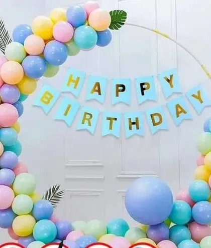 A beautiful pastel rainbow balloon arch on a circular frame. This decoration is perfect for any birthday and includes a "Happy Birthday" banner.