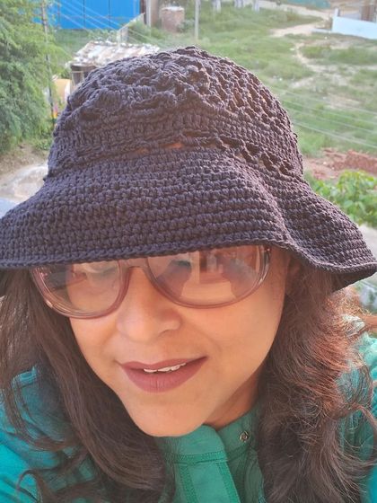 A side profile view of our black crochet bucket hat, showing its comfortable fit and the intricate stitch work on the crown.