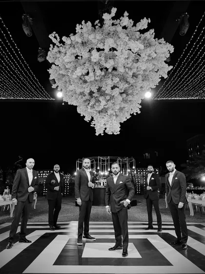 A wide shot of the Kudos team under the incredible floral centerpiece at the Bahrain reception. The production level was insane.