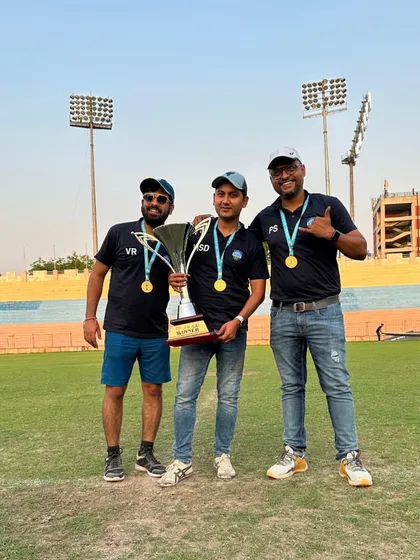 Our coaching and management team celebrating a championship win, a testament to the leadership that drives our success.