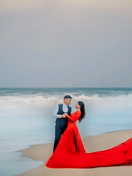 The drama of the sea meets the elegance of this flowing red gown. For this beach pre-wedding shoot, I wanted to create a powerful, vibrant image that felt both romantic and epic. The contrast of the red against the moody sky and waves makes this a standout shot.
