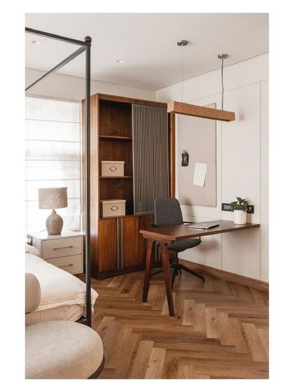 We seamlessly integrated a sleek, functional workspace into the master bedroom, complete with a pinboard and ample storage.