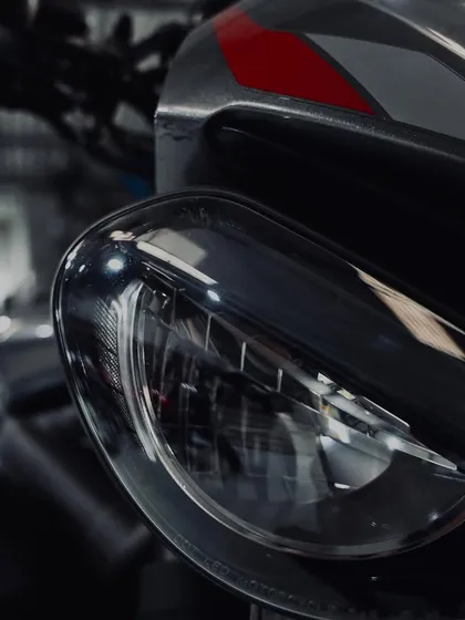 The distinctive "bug-eye" headlights of the Triumph Street Triple.