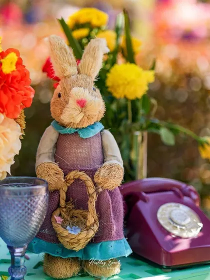 A charming detail from a fairytale-themed event. A vintage-style rabbit doll sits next to an old-fashioned telephone, adding a touch of nostalgia and whimsy.