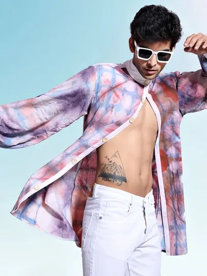 Capturing movement in a multi-colored tie-dye shirt. The flowing fabric and the model's pose create a sense of freedom and energy, perfect for a vibrant fashion brand.