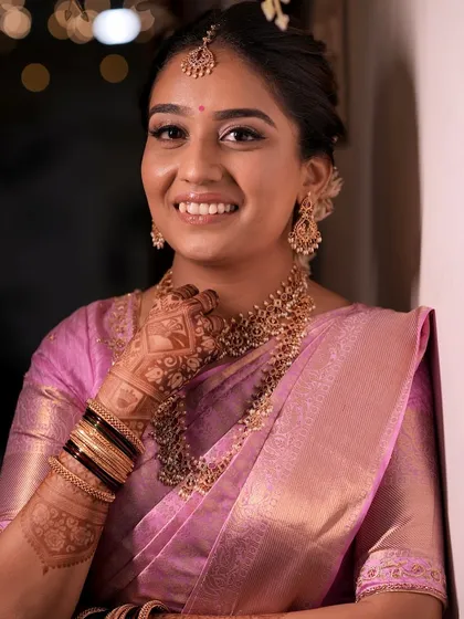Lithika's radiant smile captures the joy of her wedding day. Her makeup is soft and luminous, enhancing her natural beauty without overpowering her features.