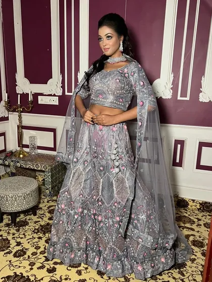 Another angle of the grey embroidered lehenga, showing how the cape sleeves create an elegant and flowing silhouette.