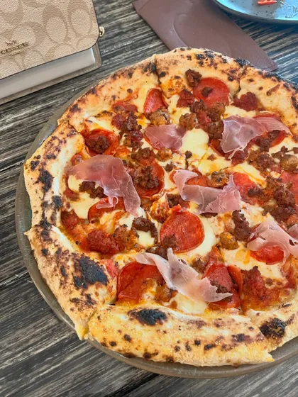 This is my Soho Pizza, a meat lover's dream. It's loaded with spicy pepperoni, ground lamb, and Nduja salami for a powerful punch of flavor.