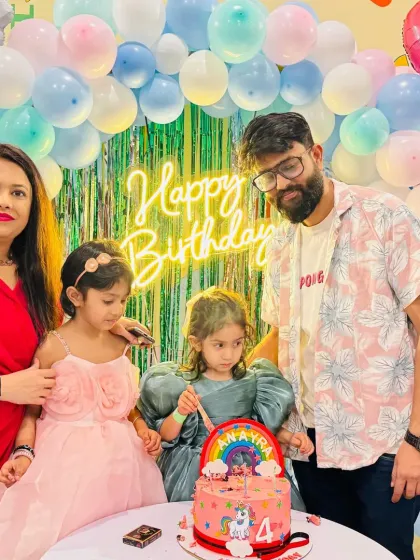 A family celebrating a 4th birthday. The cake-cutting moment is always a highlight of the party.