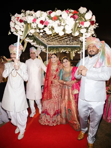 The bride's grand entrance under a beautiful 'phoolon ki chaadar'. This is always an emotional and picturesque moment of the wedding.