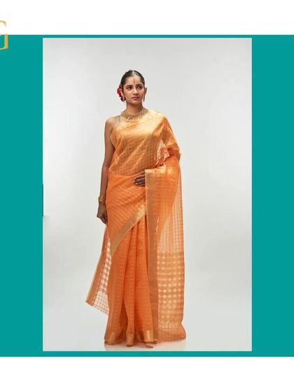 The full silhouette of the orange iced tea saree, a perfect blend of warmth and sophistication.