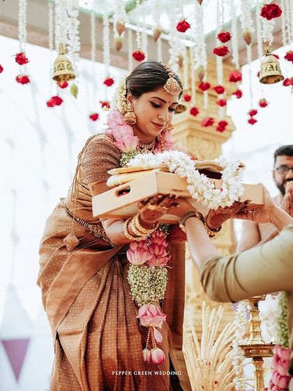 The groom receives a garland from the bride, a moment of exchange and mutual respect during the ceremony.