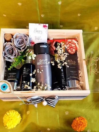 This premium Rakhi hamper for a brother is all about luxury. It includes a David Beckham deodorant, a complete grooming kit, and other high-end treats in a clear-top wooden box.
