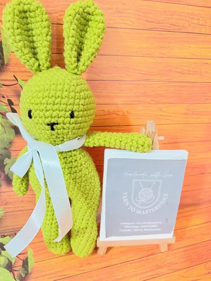 This 8-inch lime green bunny has a fluffy white feather yarn tail, adding a fun textural element.