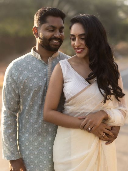 A gentle and intimate embrace during their engagement session. The soft focus and their serene expressions create a feeling of quiet, comfortable love, captured in the beautiful Delhi outdoors.