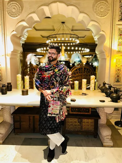 A stylish look for a 'Mehfil' night, wearing a printed shawl over a black kurta.