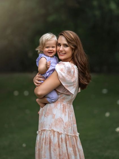 For mothers of infants, every moment is precious. This outdoor portrait captures that fleeting stage, the gentle hold and the sweet smiles, creating a memory to hold onto long after they've outgrown your arms.