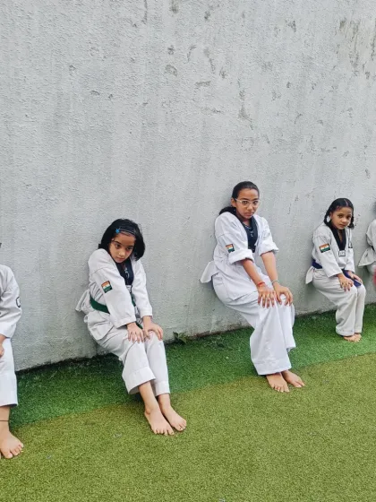 More wall sits. The focus and determination on their faces show that they understand that building strength requires pushing through discomfort.