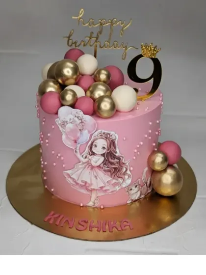 A pretty pink cake for Kinshika's 9th birthday. This chocolate mousse cake is decorated with a cute girl topper and a cascade of pink and gold spheres.