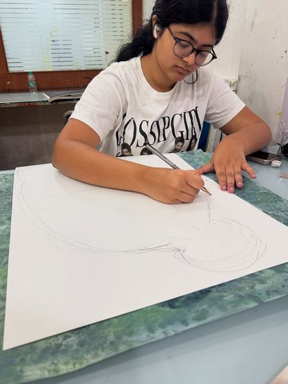 Every great artwork begins with a line. A student carefully lays out the foundational drawing for a new piece. This initial stage of planning and composition is a critical part of the artistic process we teach.