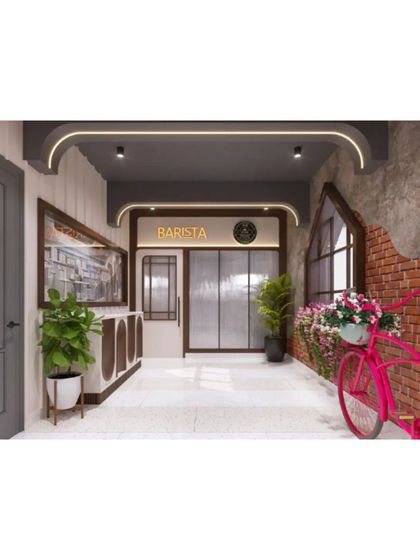 The entrance corridor of Evam Barista, combining exposed brick, modern lighting, and playful decor to create a welcoming first impression.