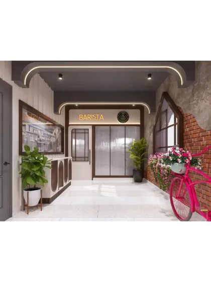 The entrance corridor of Evam Barista, combining exposed brick, modern lighting, and playful decor to create a welcoming first impression.