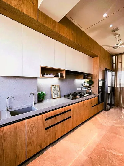 A beautiful kitchen that blends natural wood tones with clean white cabinets. The open shelving and under-cabinet lighting create a warm and functional workspace.